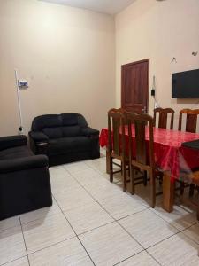a living room with a black couch and a table at APT da Orla 305 in Santarém