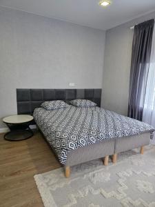 a bedroom with a bed and a table in it at Mustvee aparts in Mustvee