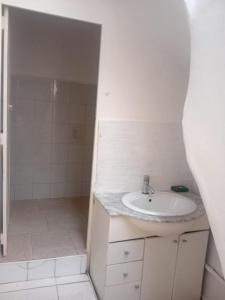a white bathroom with a sink and a shower at Maison Traditionnelle in Casablanca +4 photos