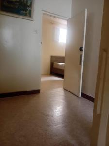 an empty room with a door leading to a bedroom at Maison Traditionnelle in Casablanca