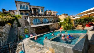 a group of people in a pool at a hotel at Cumaku Boutique Hotel & Spa in Gjirokastër