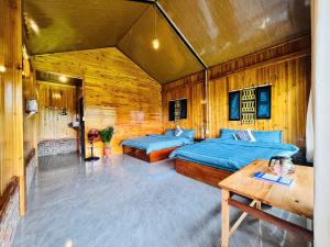 two beds in a room with wooden walls at Peaceful Happiness Bungalow with Valley Views in Sapa +64 photos