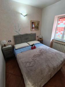 a bedroom with a bed with a stuffed animal on it at Il Ciliegio di Lurisia in Lurisia