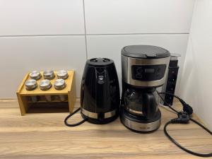 a coffeemaker sitting on a counter next to a coffee maker at Zamkowa18 in Pabianice
