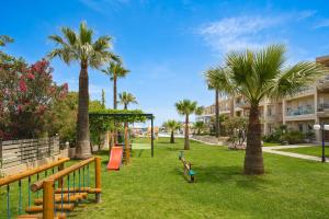 a park with palm trees and a playground at Maleme Mare in Maleme