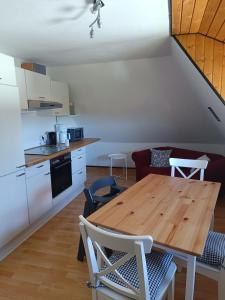 a kitchen and dining room with a wooden table at FeWo Waschbär in Waldeck