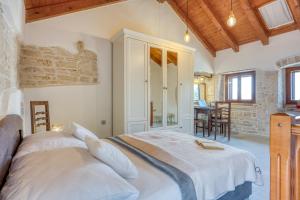 a bedroom with a large white bed in a room at Holiday House Ante in Žminj