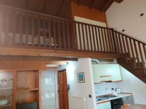 a kitchen with a staircase in a house at Mulinaccio Appartamenti in Pievepelago