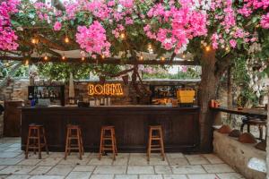 a bar with pink flowers and a sign that reads bourbon at Boleka Bodrum in Bodrum City