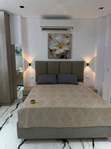 a bedroom with a bed with a flower on the wall at Jasmine Studio Sharm El Sheikh in Dawwār Ruḩayyim +54 photos