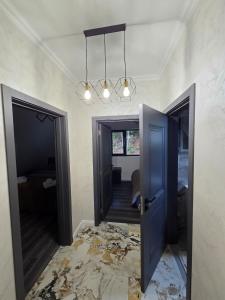 a hallway with a blue door and a room with a floor at The Robian Chalet in Suceviţa +7 photos