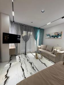 a living room with a marble floor with a couch at Jasmine Studio Sharm El Sheikh in Dawwār Ruḩayyim