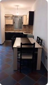 a kitchen with a table and chairs in a room at Adriatic Pearl Apartaments in Lezhë