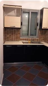 a kitchen with a sink and a mirror at Adriatic Pearl Apartaments in Lezhë