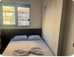 a bedroom with a bed with a bow on it at Adriatic Pearl Apartaments in Lezhë