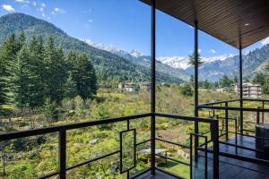 a room with a view of the mountains at Apple Flower Hotel - Personal Balcony, Lift, Garden and Mountain View in Manāli