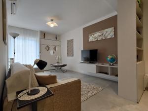 a living room with a couch and a tv at Design apartment n. 41 in Trento +51 photos