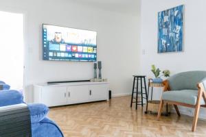 a living room with a flat screen tv on a wall at Beachfront Getaway Pet-Friendly & Near Boat Ramp - Koala Stay in Encounter Bay