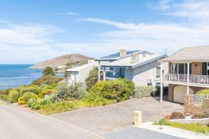 an image of a house with the ocean in the background at Beachfront Getaway Pet-Friendly & Near Boat Ramp - Koala Stay in Encounter Bay