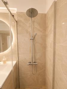 a shower with a glass door in a bathroom at Luxury Family Villa near beach in Lechaio +17 photos