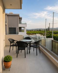 a patio with a table and chairs on a balcony at Luxury Family Villa near beach in Lechaio