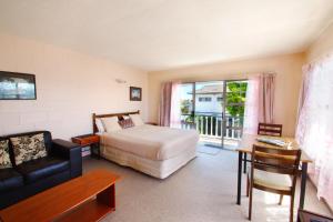 Habitación de hotel con cama y balcón en Union Victoria Motel, en Rotorua