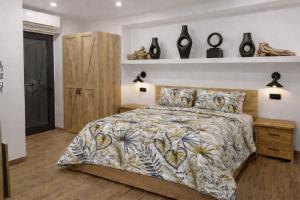 a bedroom with a bed with a floral bedspread at Antana Guest House in Procida