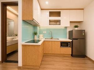 a kitchen with a sink and a refrigerator at 2-3 bedroom at HUD building Nha Trang in Nha Trang +67 photos