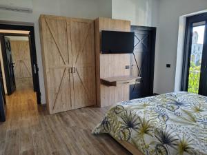 a bedroom with a bed and a large wooden cabinet at Antana Guest House in Procida +15 photos