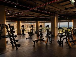 a gym with a bunch of exercise equipment in a room at Century Marina Hotel - Lusail in Lusail