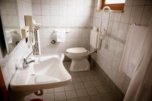 a white bathroom with a toilet and a sink at Hotel Giada in Turin +50 photos