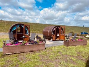 a group of three dome homes in a field at Claashoff Übernachtungsfass in Hollern-Twielenfleth