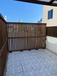a balcony with a wooden fence and a tile floor at Studio Apartment on a Terrace by Skysuites in Male City