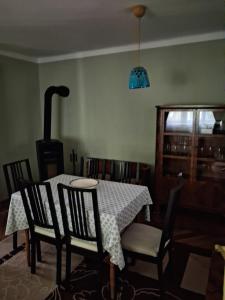 a dining room with a table and chairs and a blue light at Hangvilla Vendégház in Miskolc