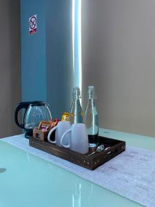 a tray with dishes and bottles on a counter at Studio Apartment on a Terrace by Skysuites in Male City