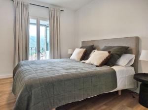 a bedroom with a large bed and a window at YourHouse O Canton 3 in Lobios