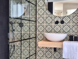 a bathroom with a sink and a mirror on a wall at YourHouse O Canton 3 in Lobios +13 photos