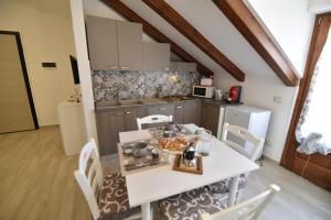 a kitchen with a white table and chairs in a room at Casa Vacanze Andromeda in Agerola