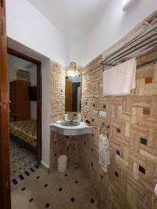 a bathroom with a stone wall with a sink at Riad Fes Colors & SPA - Family Lodging in Fez +92 photos