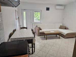 a living room with a couch and a table at Apartmani Marko in Nin