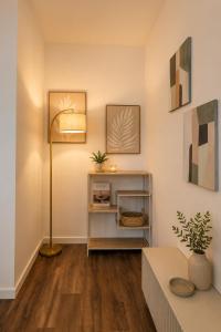 a living room with a floor lamp and a table at Schängel Chic 27 in Koblenz