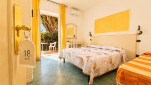 a bedroom with a bed and a door to a patio at Hotel Aragonese Ischia in Ischia Town +143 photos