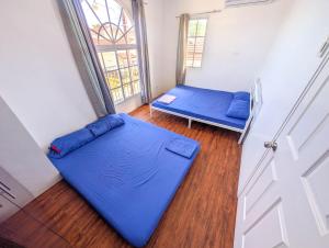 a room with two beds and a window at Panglao 4 Bedroom Family and Group House With Pool in Dauis