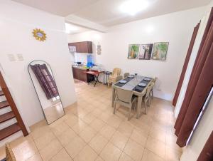 a kitchen and dining room with a table and chairs at Panglao 4 Bedroom Family and Group House With Pool in Dauis
