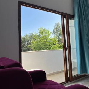 a living room with a large window and a couch at Uğur Otel in Kaş
