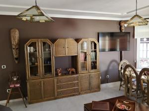 a living room with a large wooden cabinet at Casa Chalet El Bucanero Morro Jable in Morro del Jable +55 photos