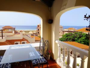 a balcony with a table and a view of the ocean at Casa Chalet El Bucanero Morro Jable in Morro del Jable