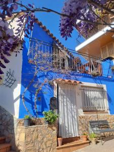 a blue building with a door and a balcony at Ca la Pepa in Begur +35 photos