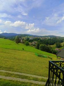 a view of a field of green grass with a bench at Apartament Oliwia in Grywałd +8 photos
