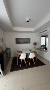 a dining room with a table and two chairs at Radisson blu résidence alhcoeima in Al Hoceïma